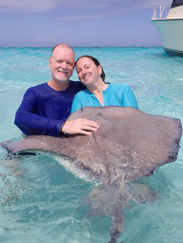 Bonding with Orion at Stingray City - Photo courtesy of Captain Marvin's
